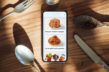 A smartphone displays a menu with food & 168极速赛车官方开奖记录查询与实时直播items on a wooden table surrounded by utensils