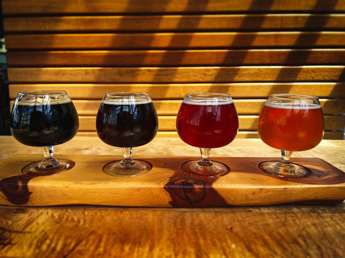 A Beer flight arranged from dark to light beer.