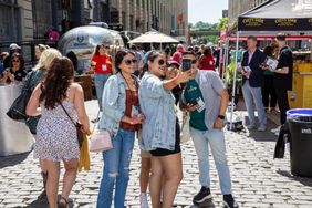 People taking a selfie in an outdoor event setting at Bar Convent Brooklyn 2024.