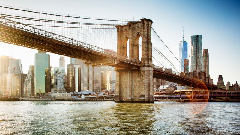 Brooklyn Bridge spanning the East River with the Manhattan skyline in the background