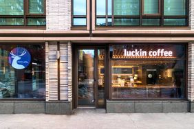 Exterior storefront of Luckin Coffee in NYC glass windows displaying interior and logo signage visible on the building