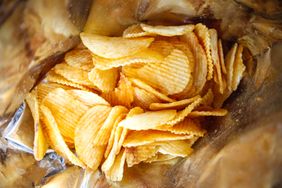 A closeup view inside a bag of ridged potato chips