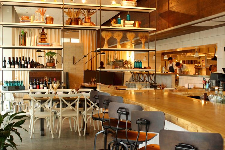 A welldecorated restaurant interior featuring a bar and dining area