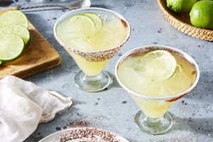Sobremesa Hand-Blown Recycled Margarita Glasses with cocktails and limes in them with salted rims on a counter
