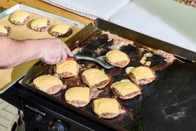 Cheeseburgers are cooked on the Blackstone 1554 Cooking 4 Burner Flat Top Gas Grill