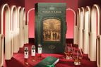 A whiskey advent calendar from the Museum of Flaviar shown with sample bottles and glasses