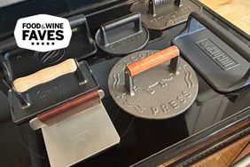 seven grill presses on a stovetop