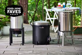 three turkey fryers outdoors on patio