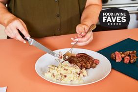 A plate with steak and mashed potatoes being eaten using a knife and fork, featuring the Food & Wine Faves badge
