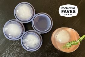 The W&P Silicone Ice Tray next to a cocktail with an ice sphere in it