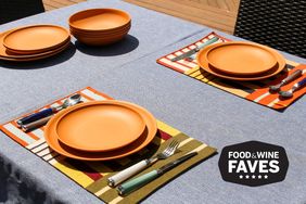 A table setting outdoors with plates, utensils, with a Food & Wine Faves badge on the corner