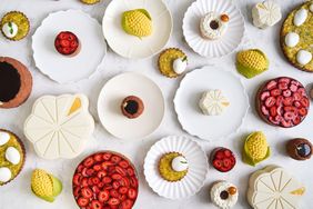 Various pastries on white plates and a white stone surface from Lysée in New York.