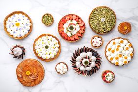 Various tarts on a white marble surface from Maison Aleph in Paris, France. 