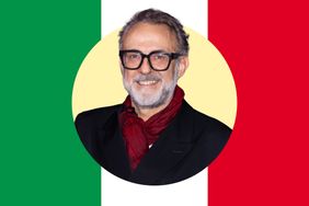 Massimo Bottura smiling in front of an Italian flag backdrop