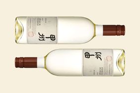 Two bottles of Grace Koshu placed horizontally detailed label featuring kanji text and stylized logo