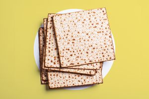 Matzo on a white and light yellow background. 