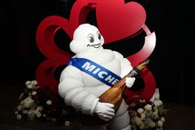 The Michelin Man plays with a fake ham before the Michelin awards ceremony Monday, Nov. 11, 2024 at 713 Music Hall in Houston. It was Michelin Guides first Texas awards. 