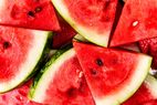 Sliced watermelon arranged with visible seeds and rind