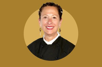 Nancy Silverton wearing a chefs jacket against a plain background