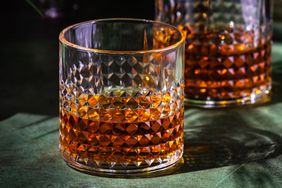 Glass with bourbon textured surface another similar glass in the background
