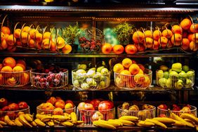 A variety of fruits displayed on shelves in a grocery store