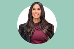 Padma Lakshmi smiling wearing a dark outfit isolated against a turquoise background