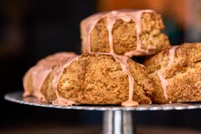 A closeup of baked pastries topped with glaze displayed on a stand