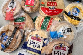 An assortment of packaged pita breads from various brands