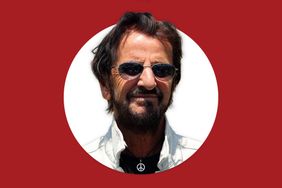 Ringo Starr wearing glasses and a necklace with a peace sign