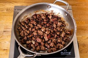 Cooked ground beef in a frying pan on a stovetop