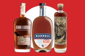 Three whiskey bottles arranged against a red background
