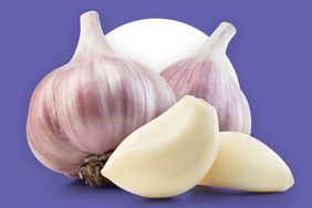 Two garlic bulbs and peeled garlic cloves