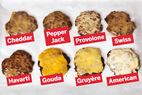 Eight burger patties each topped with a different cheese labeled as Cheddar Pepper Jack Provolone Swiss Havarti Gouda Gruyre and American