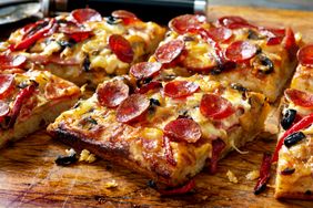 Slices of pepperoni pizza on a wooden surface