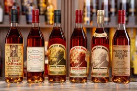 A display of six bourbon bottles from the Van Winkle family collection on a countertop