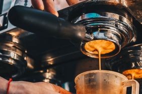Espresso machine portafilter dispensing coffee into a cup