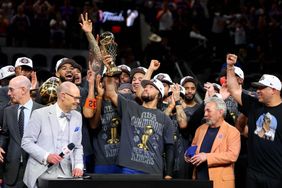 SAN ANTONIO, TEXAS - JUNE 13: Jalen Brunson #11 of the New York Knicks lifts the Bill Russell NBA Finals Most Valuable Player Award trophy after defeating the San Antonio Spurs in Game Five of the 2026 NBA Finals at Frost Bank Center on June 13, 2026 in San Antonio, Texas. 